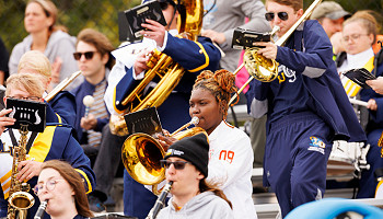 2024 homecoming photo - band performing from the bleachers at football game