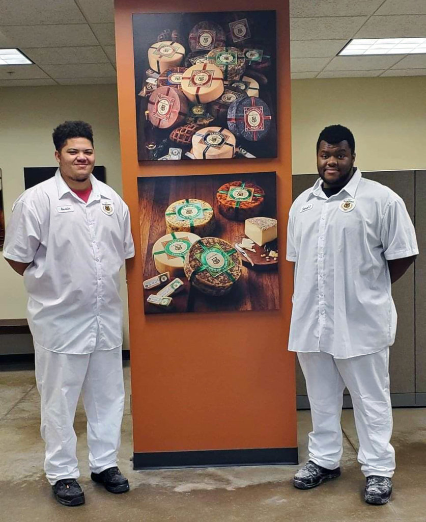 Two co-op students working at a cheese maker
