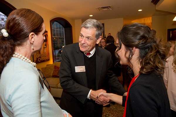 Dr. Black shaking hands and talking to alums.