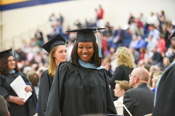 Lakeland graduate smiling at graduation ceremony.