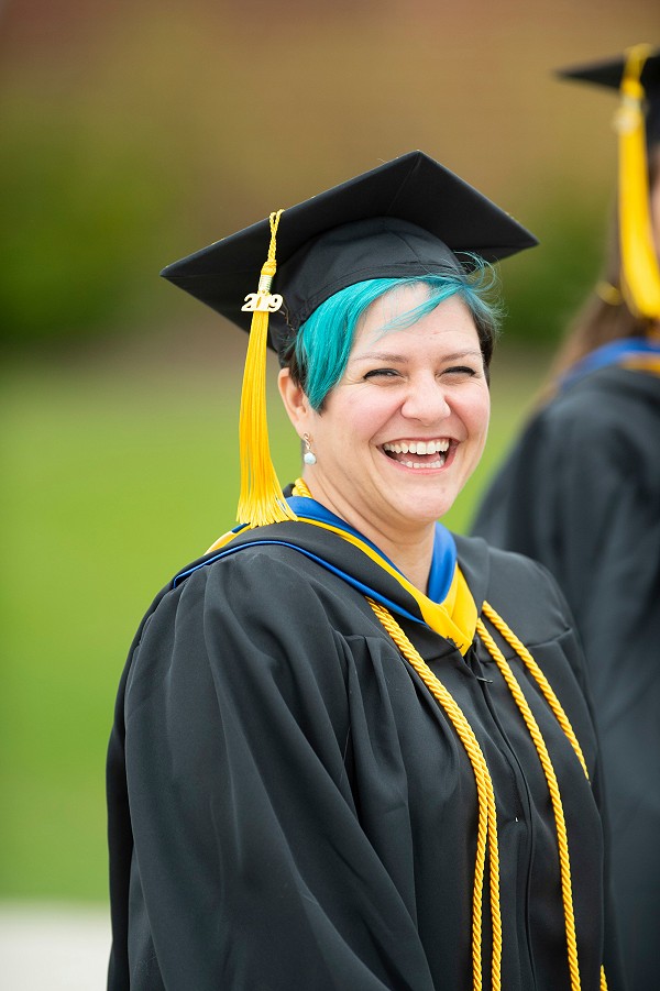 Lakeland University graduate smiling at graduation.