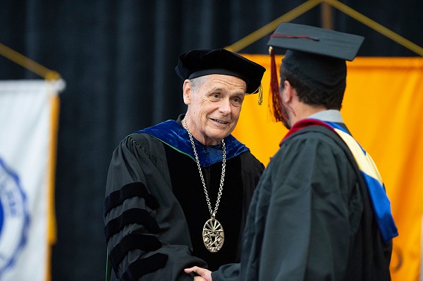 David Black shaking hand of graduate