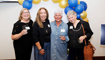 2025 homecoming photo - group standing in front of a balloon archway