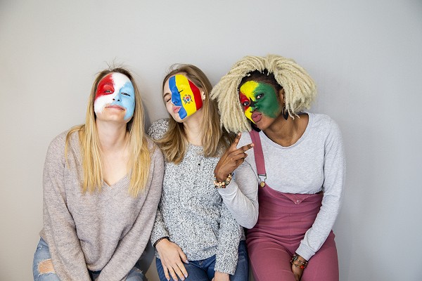 Lakeland University students with international flags painted on face.