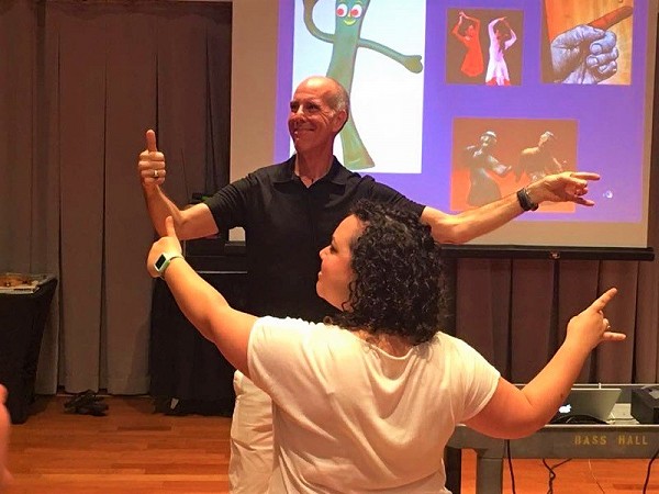 Instructor with student dancing.