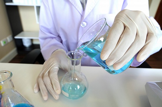 A Lakeland University student mixes liquids in a science lab.