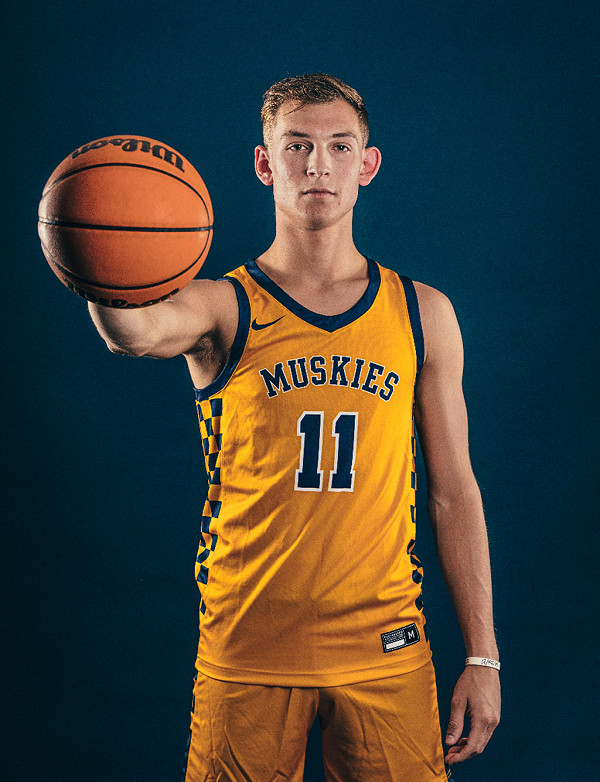 LU basketball player posing with ball.